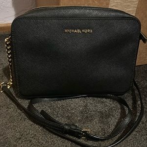 Jet Set crossbody, black with gold metal accents.